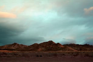 a group of mountains under a cloudy sky