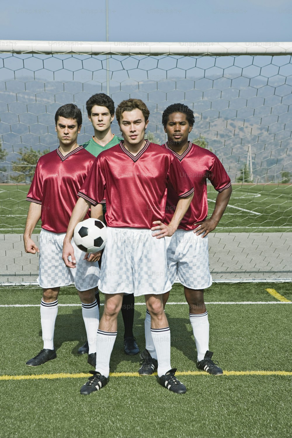 a group of young men standing next to each other on a soccer field