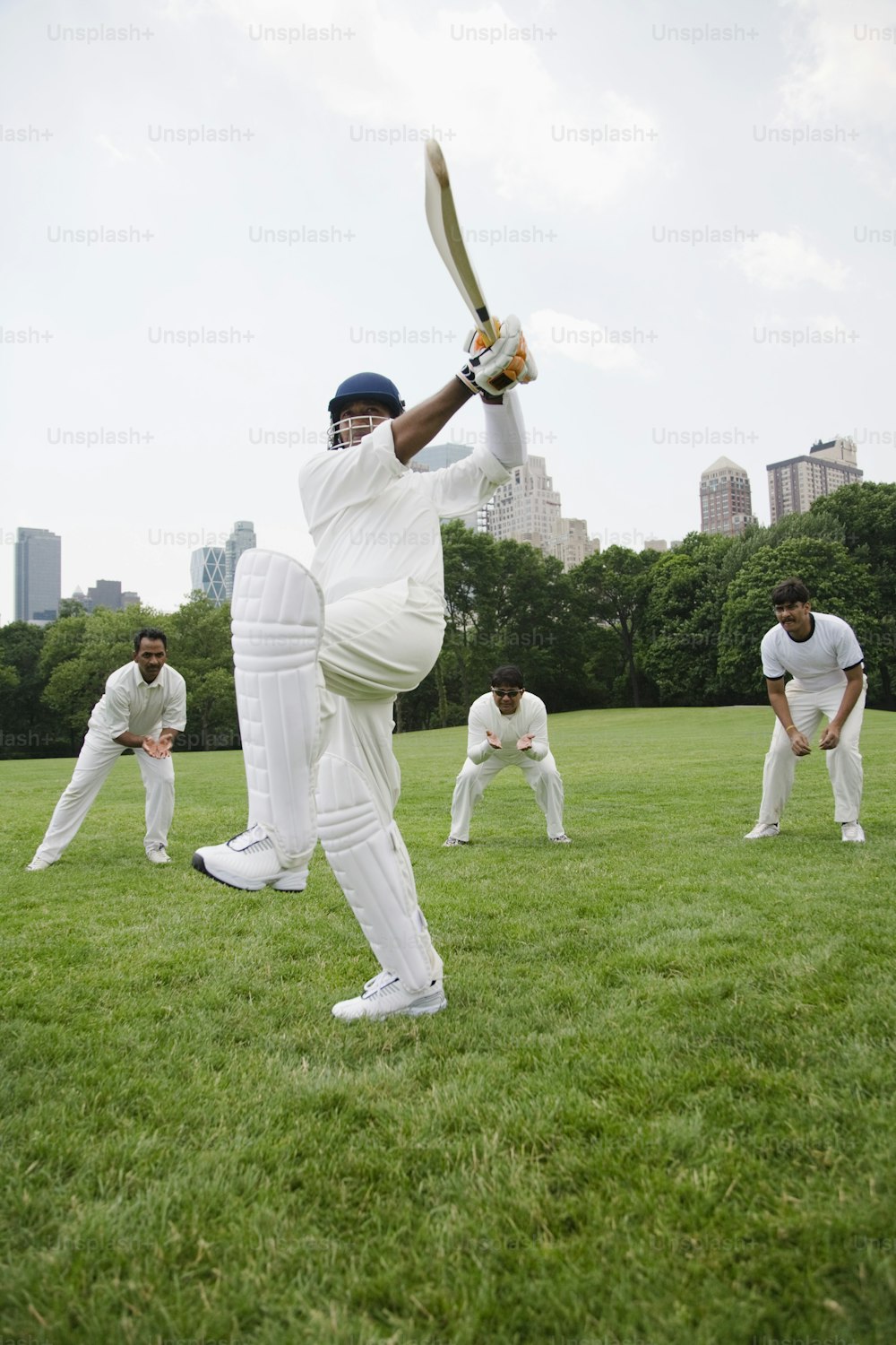 a group of men playing a game of cricket