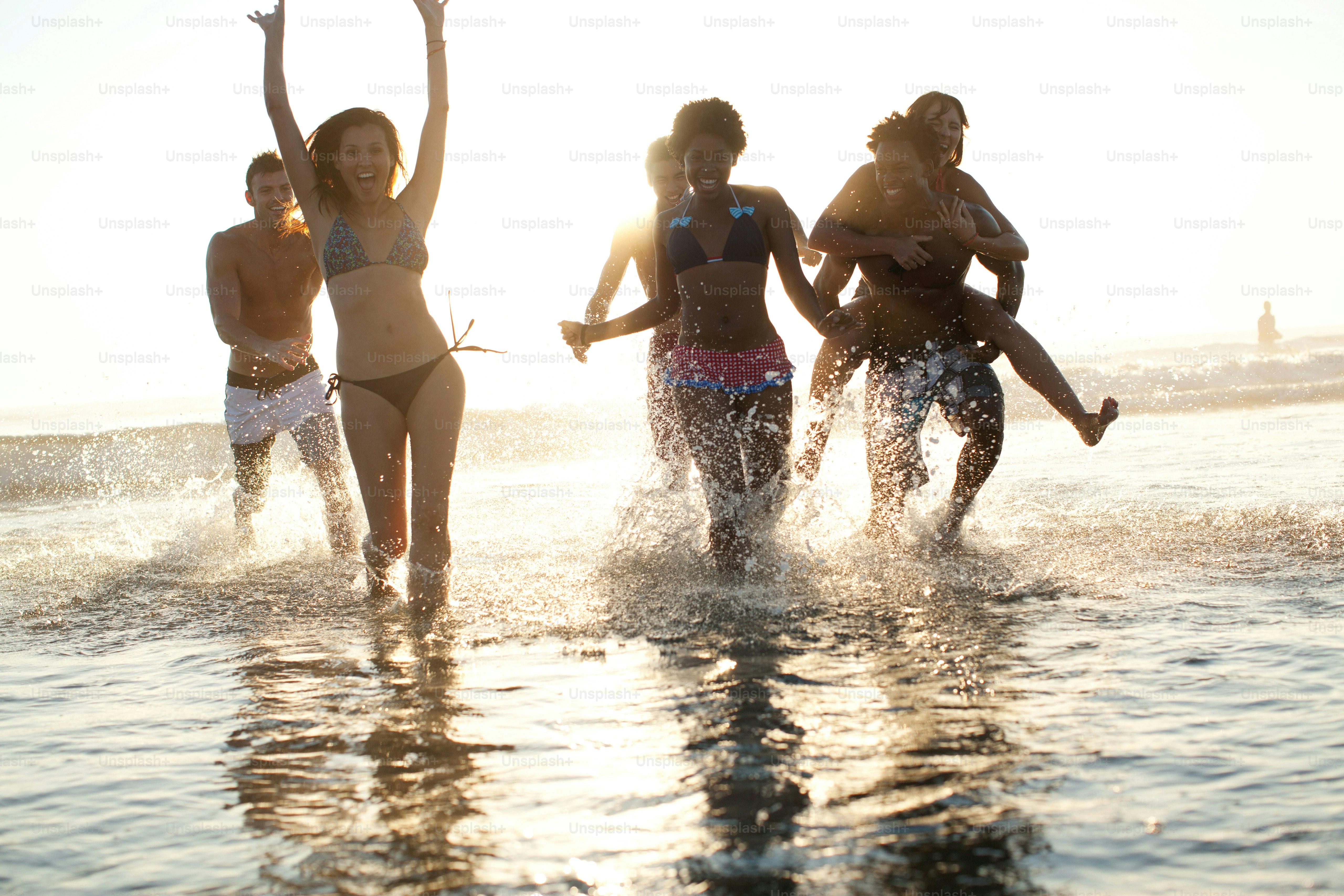 a group of young women playing in the water