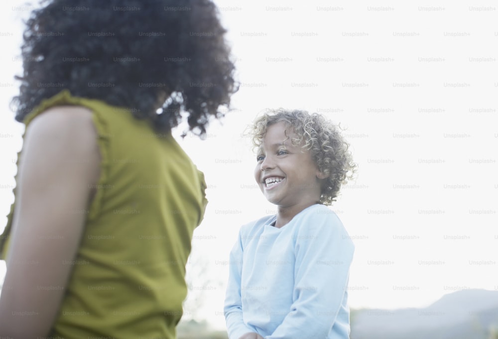 a woman standing next to a smiling child