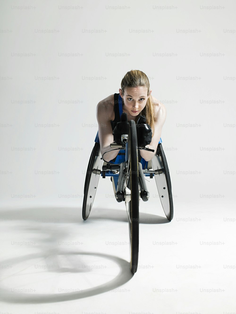 a woman sitting in a wheelchair with her arms behind her back