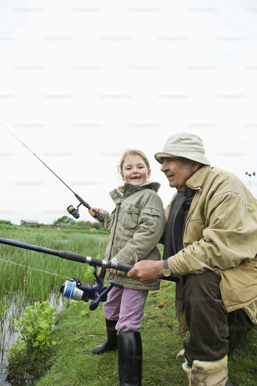 a man and a little girl fishing together