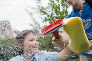 a child is playing with a hair dryer in the rain