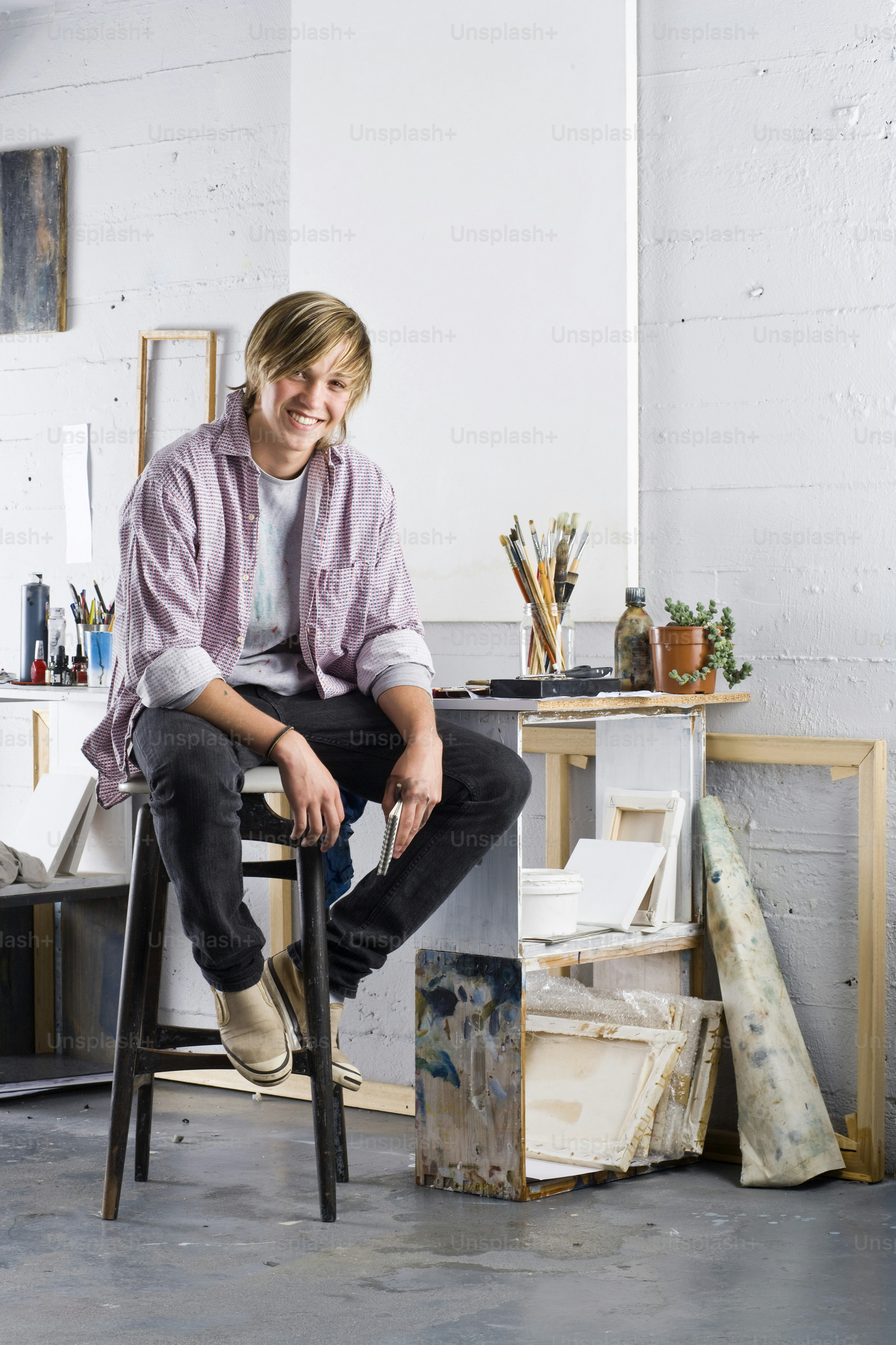 a man sitting on top of a chair in a room