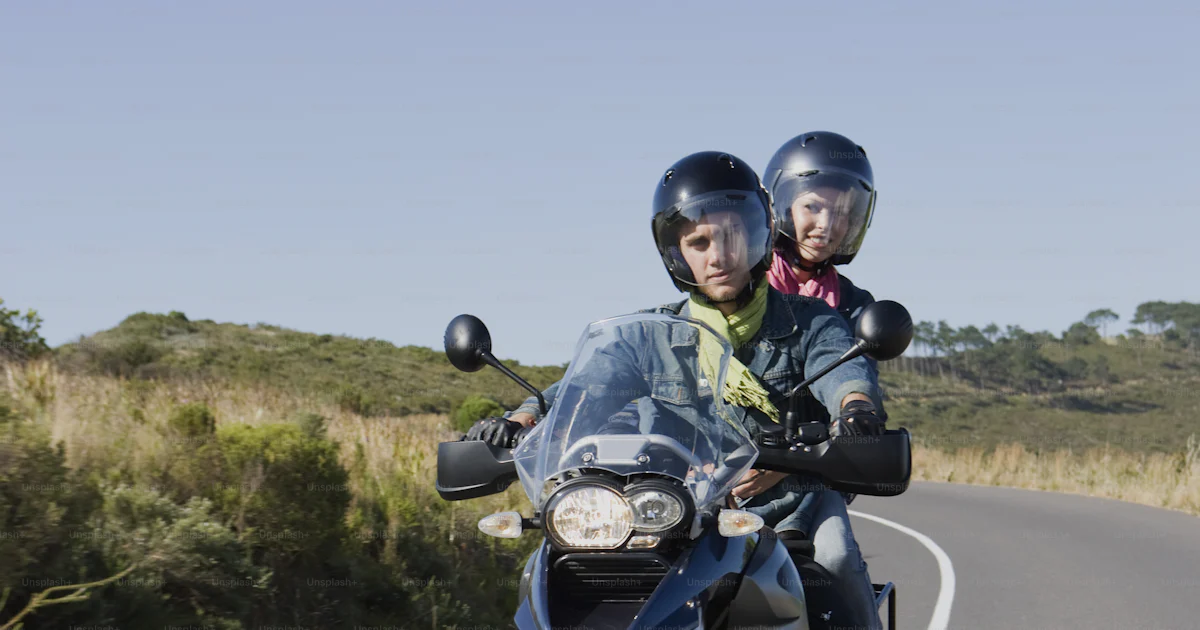 2 People Ride Motorcycle Two people riding a motorcycle on a road photo – Motos Image on Unsplash