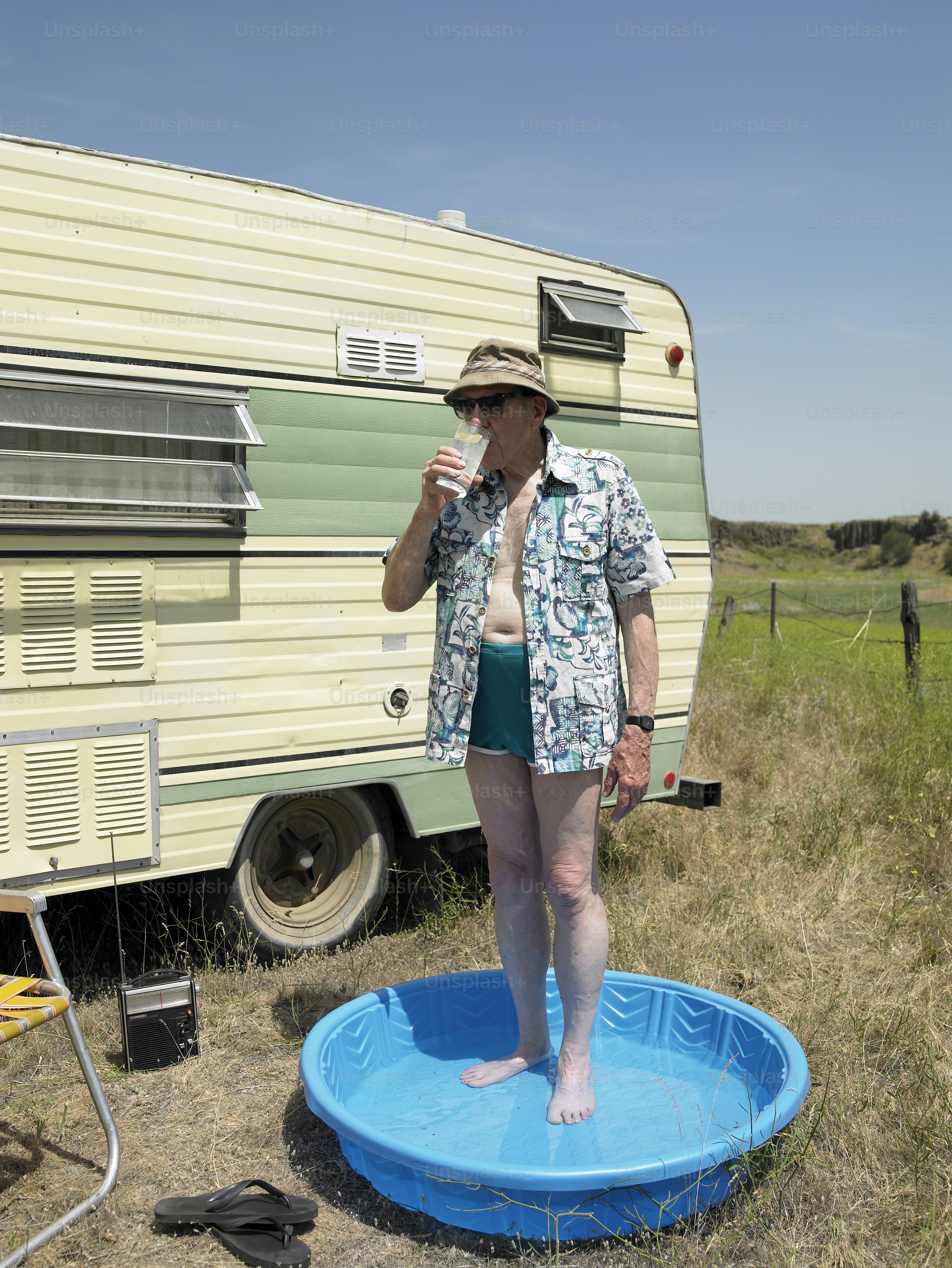 a woman standing on a blue frisbee in front of a trailer
