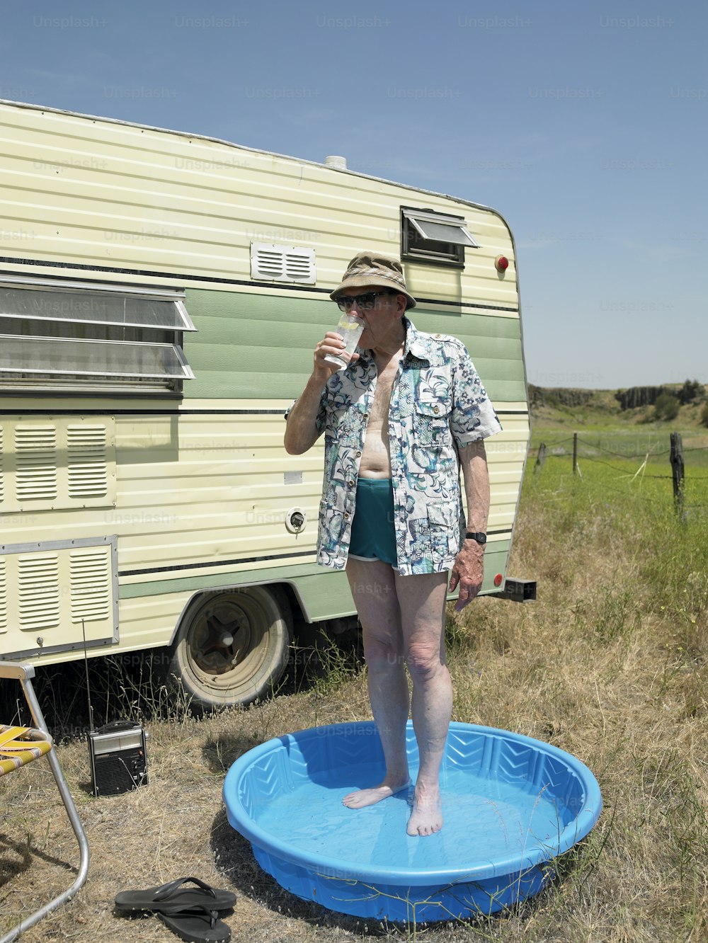 a woman standing on a blue frisbee in front of a trailer