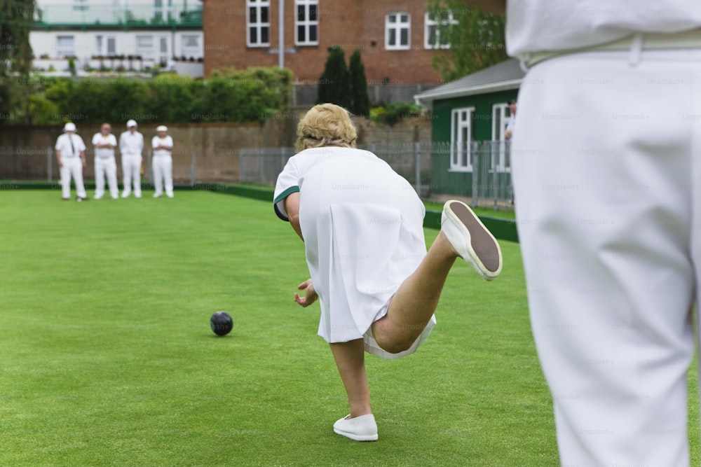 a group of people playing a game of lawn bowling