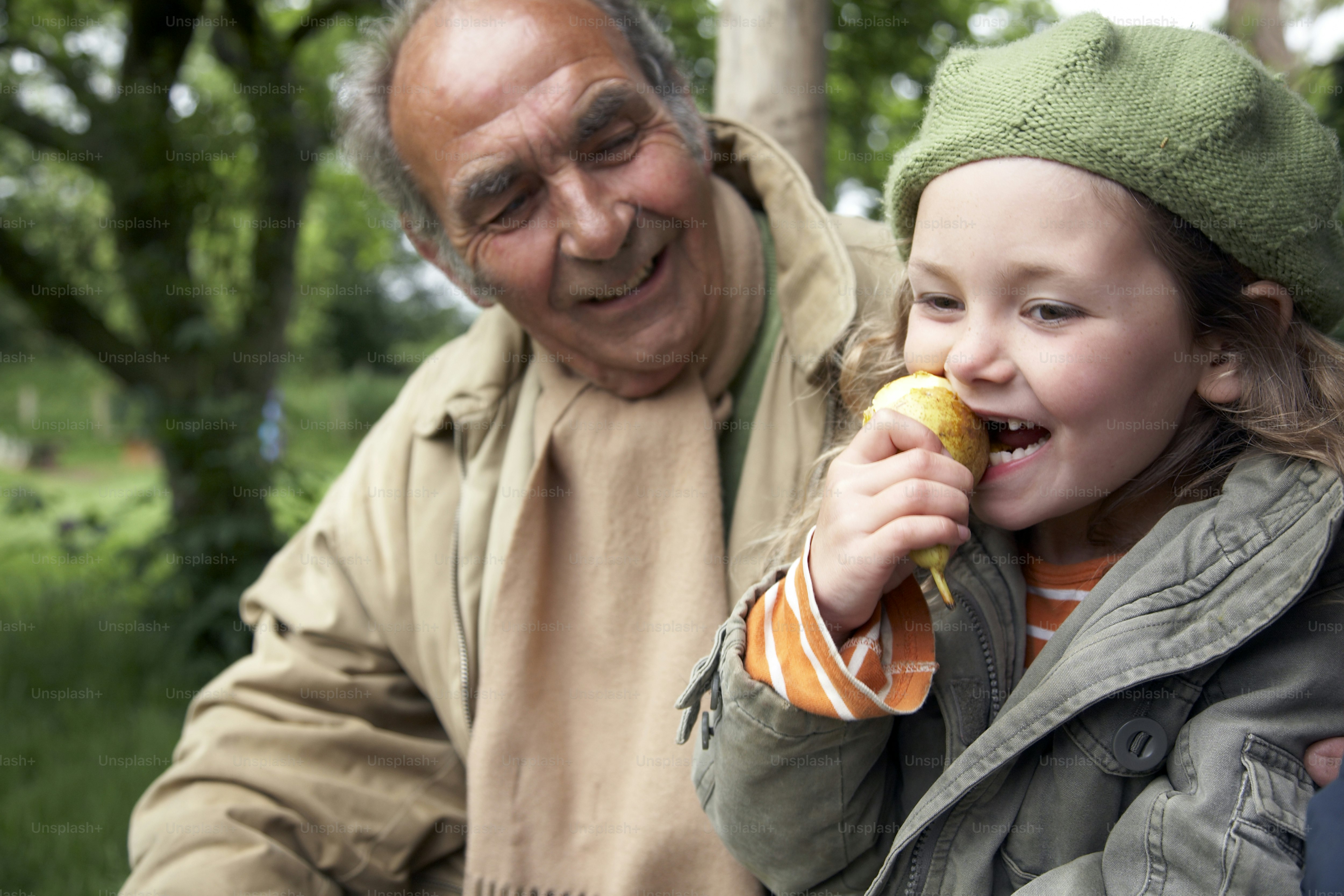 an-older-man-and-a-young-girl-eating-food-photo-adult-image-on-unsplash