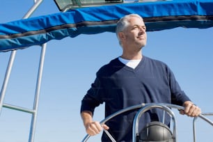 a man standing on the deck of a boat