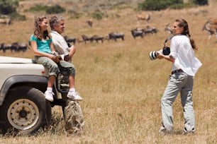 a couple of people that are standing in the grass