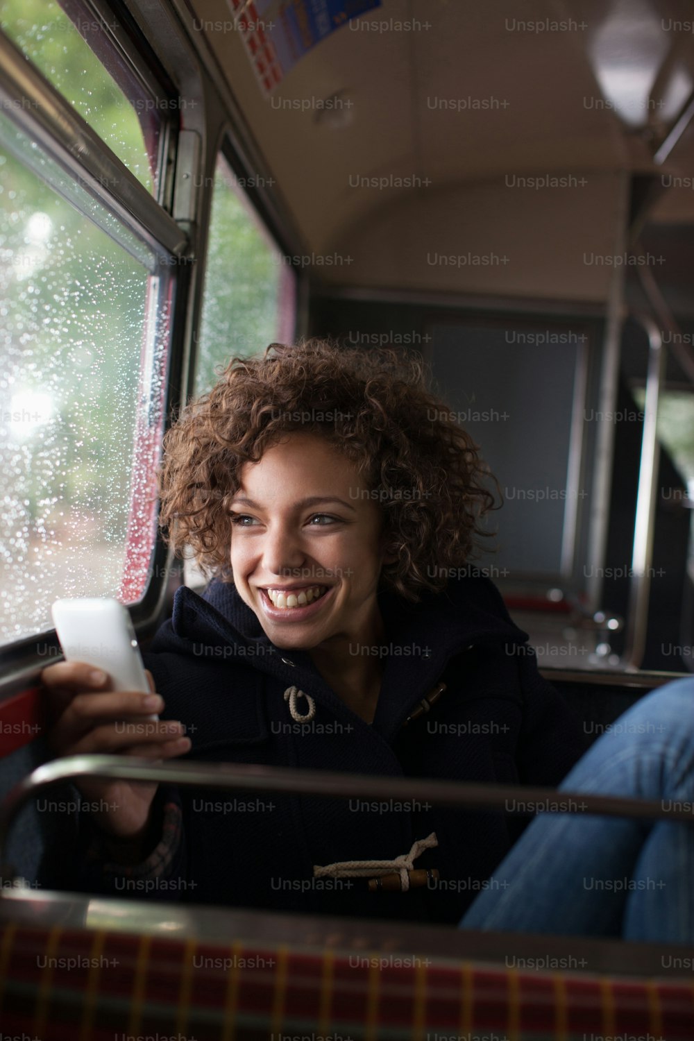 Eine Frau, die in einem Bus sitzt und eine Tasse hält