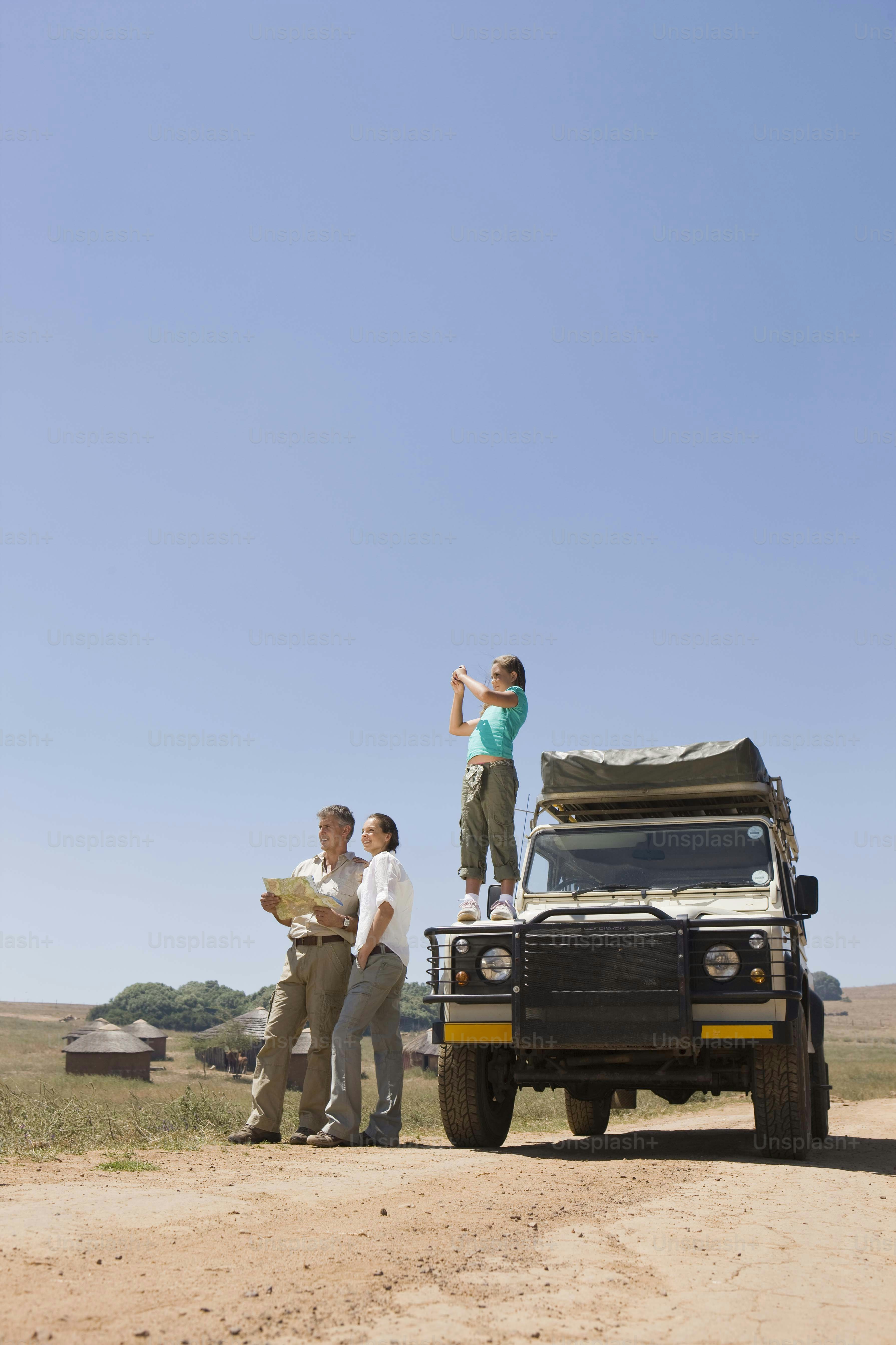 a couple of people standing on top of a vehicle