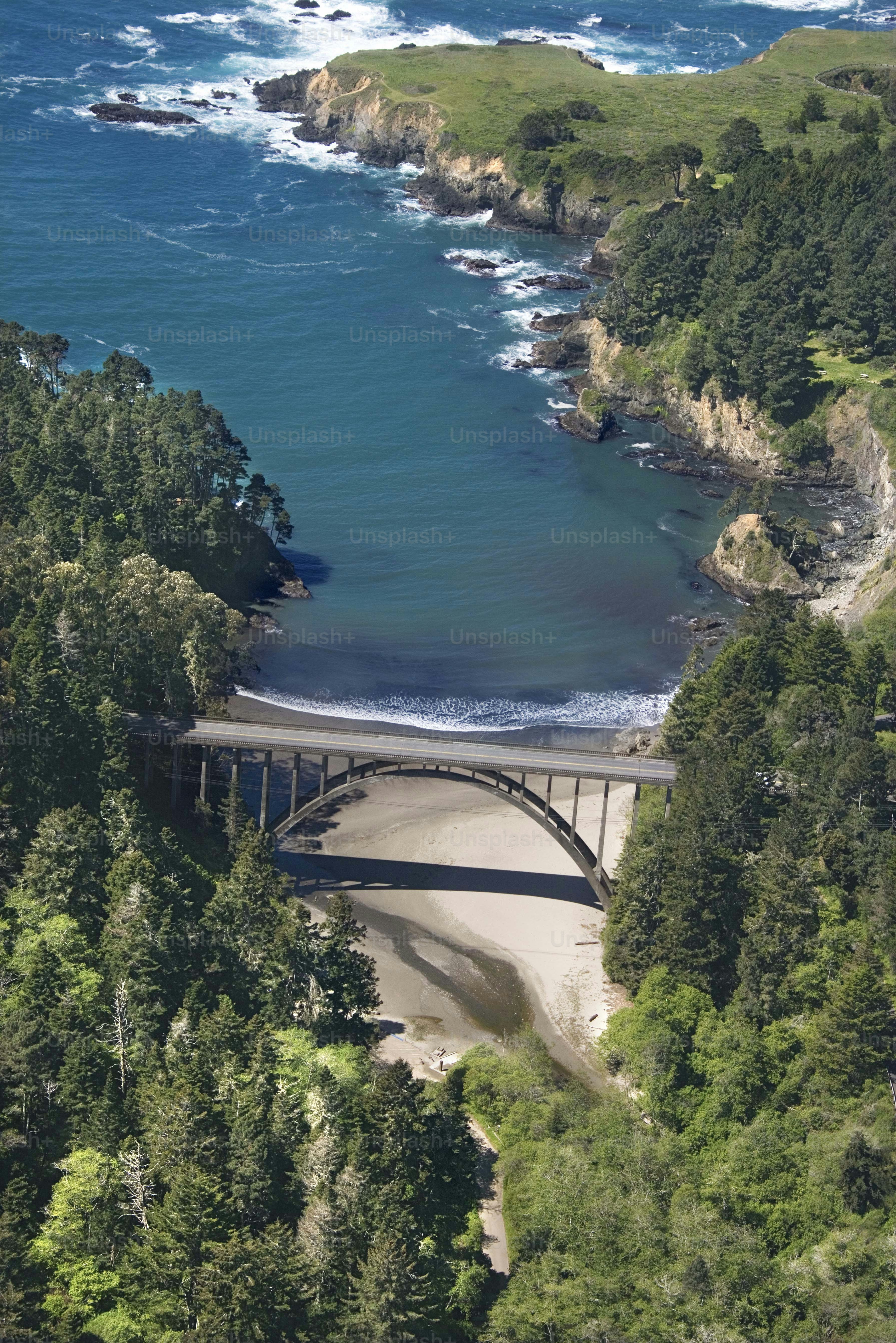 an aerial view of a bridge over a body of water
