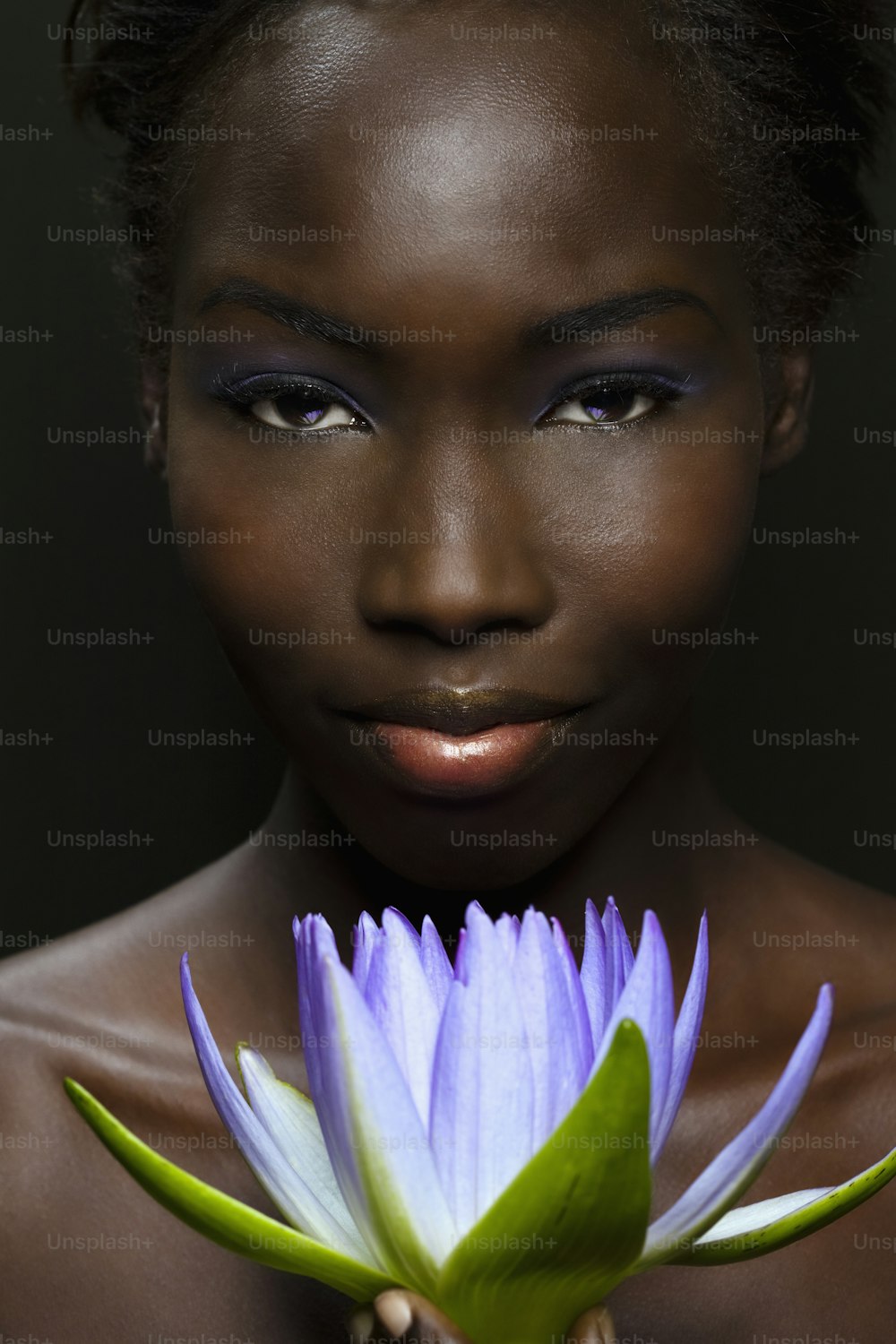 Mujer afroamericana con flor de loto púrpura