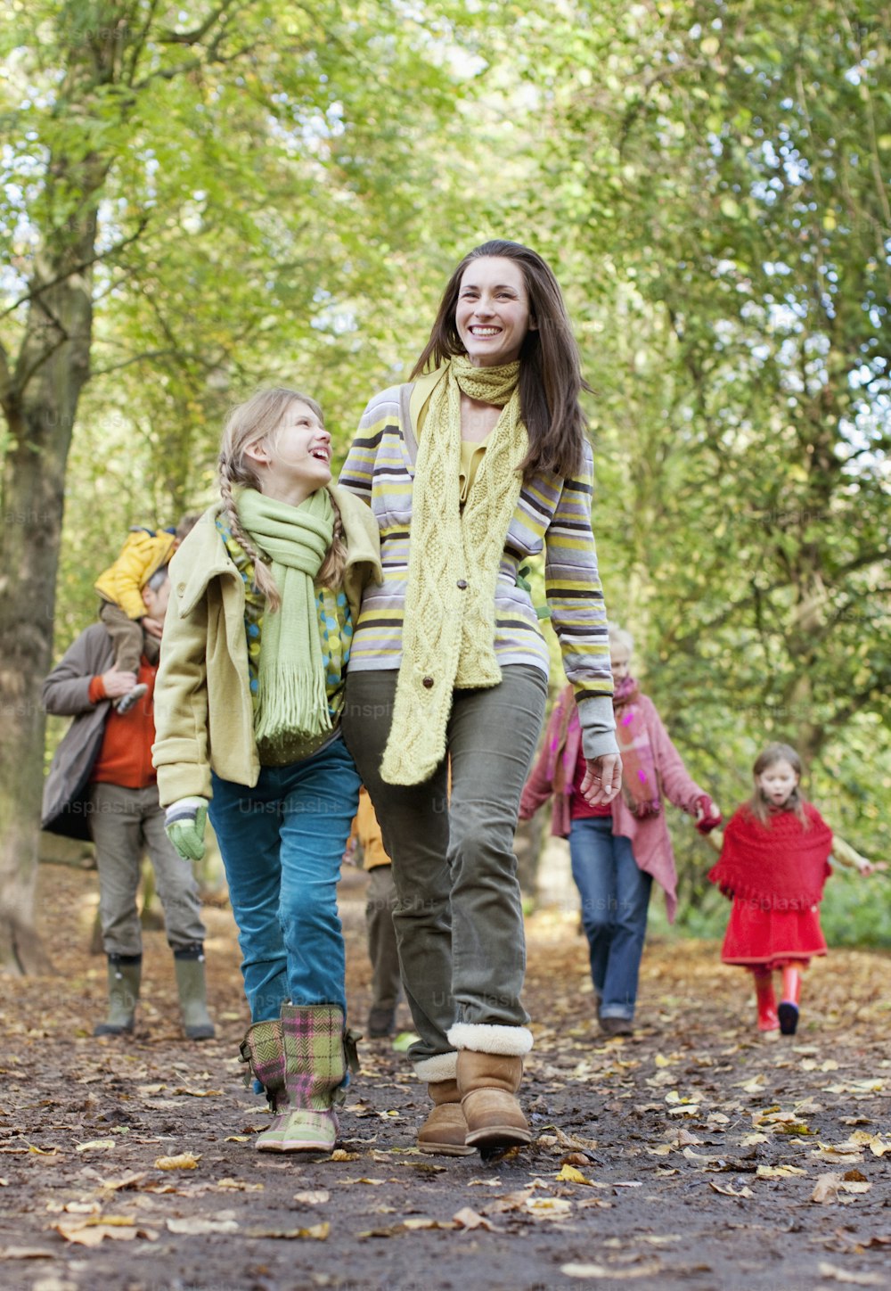 a group of people walking through a forest