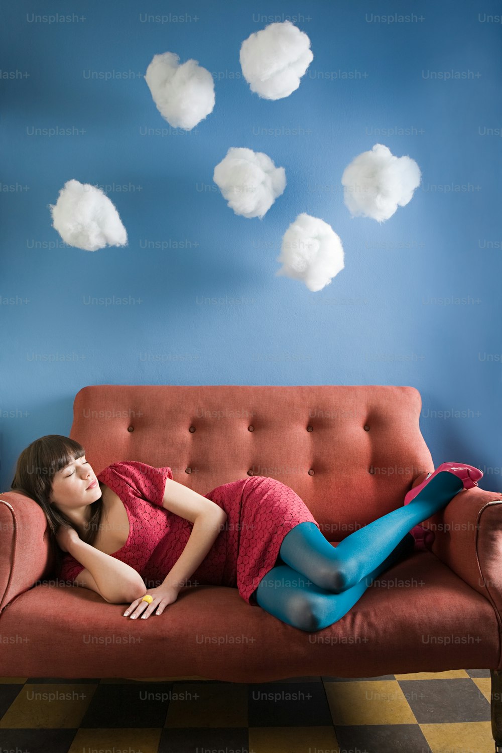 a woman laying on a couch in a room
