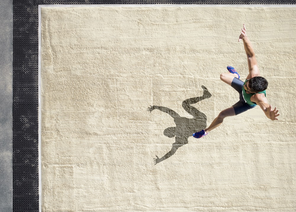 a person jumping in the air with a frisbee