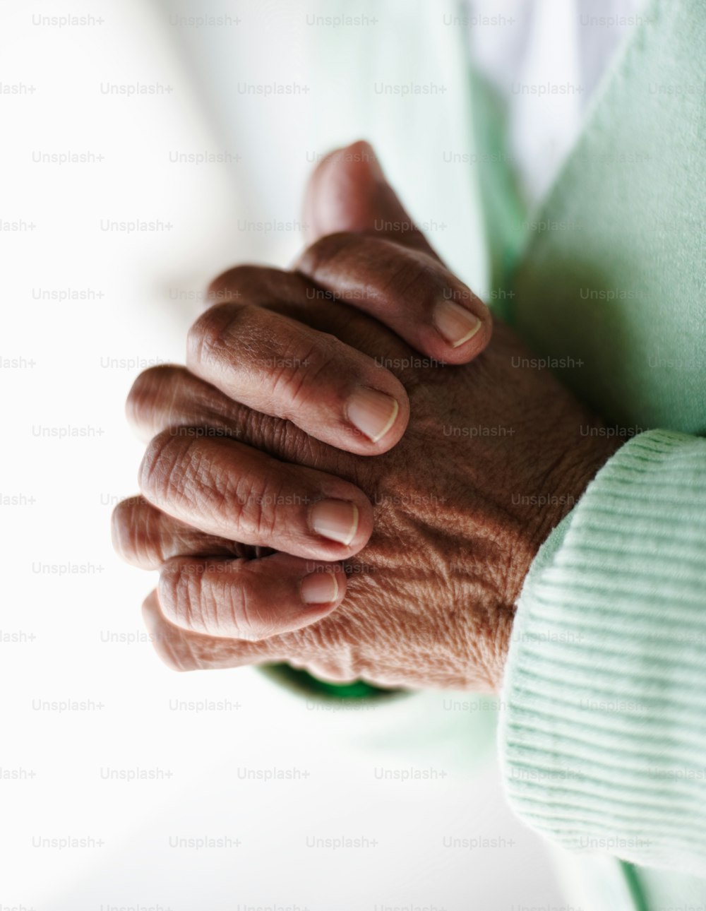 Close-up of an elderly woman's hand joined together