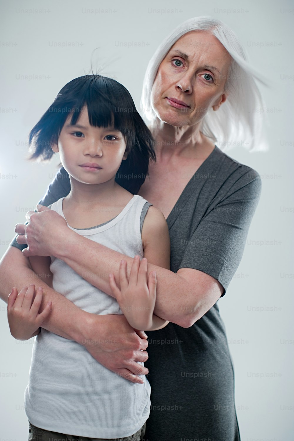 an older woman holding a young girl in her arms