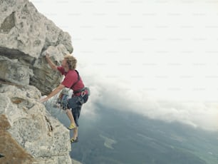 a man climbing up the side of a mountain