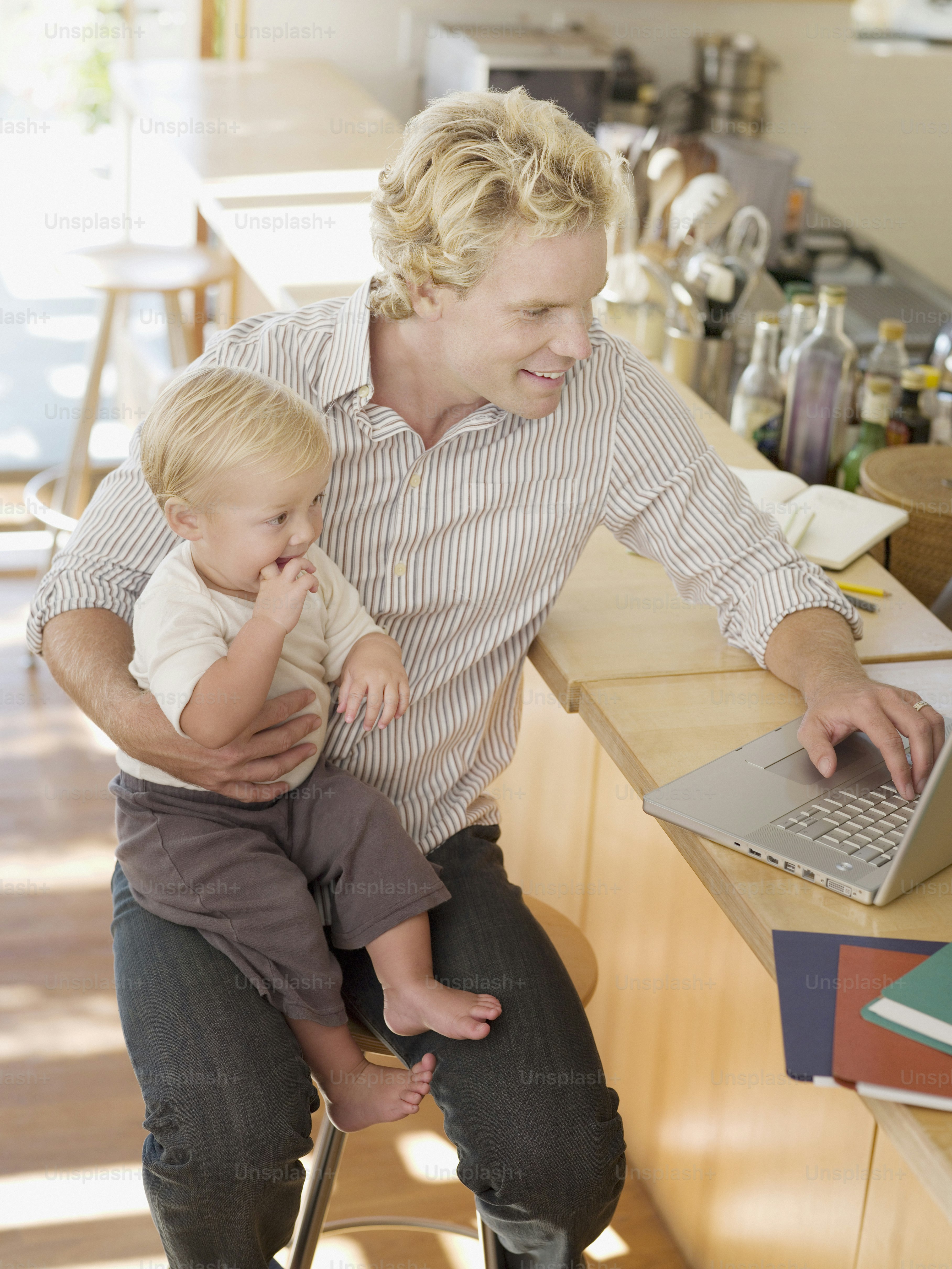 a man sitting at a counter with a child on his lap
