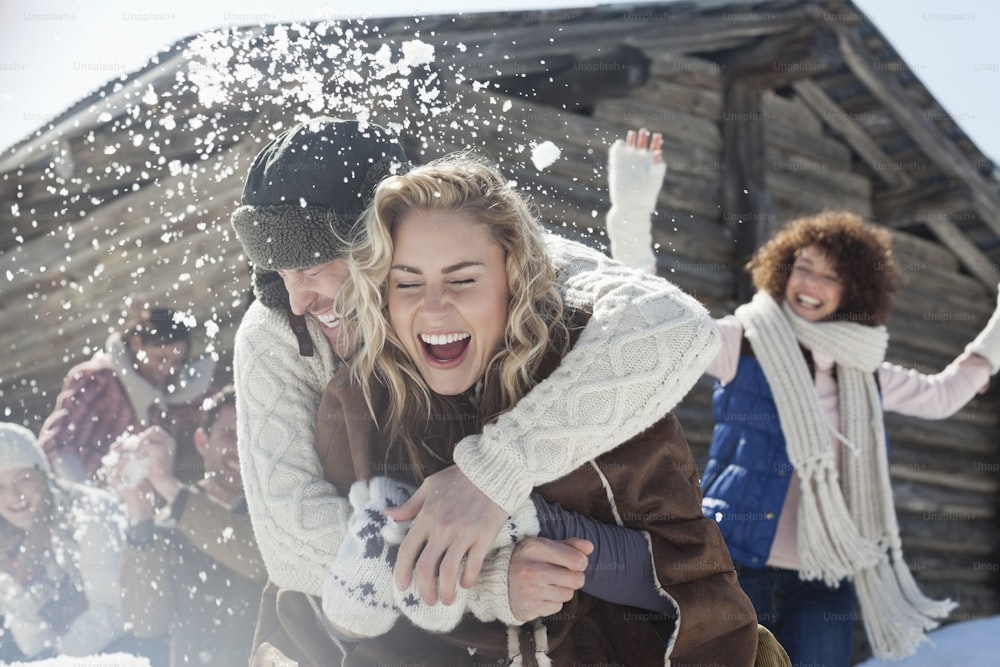 a group of people playing in the snow