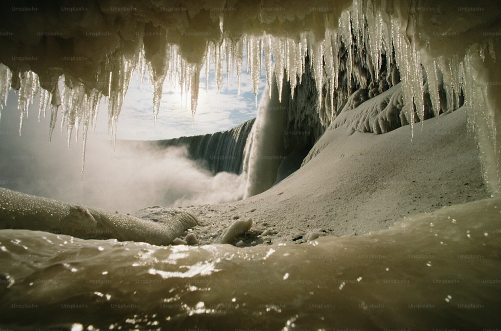 a group of icicles hanging from the ceiling of a cave