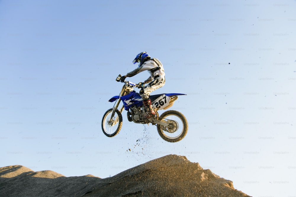 a man riding a dirt bike in the air