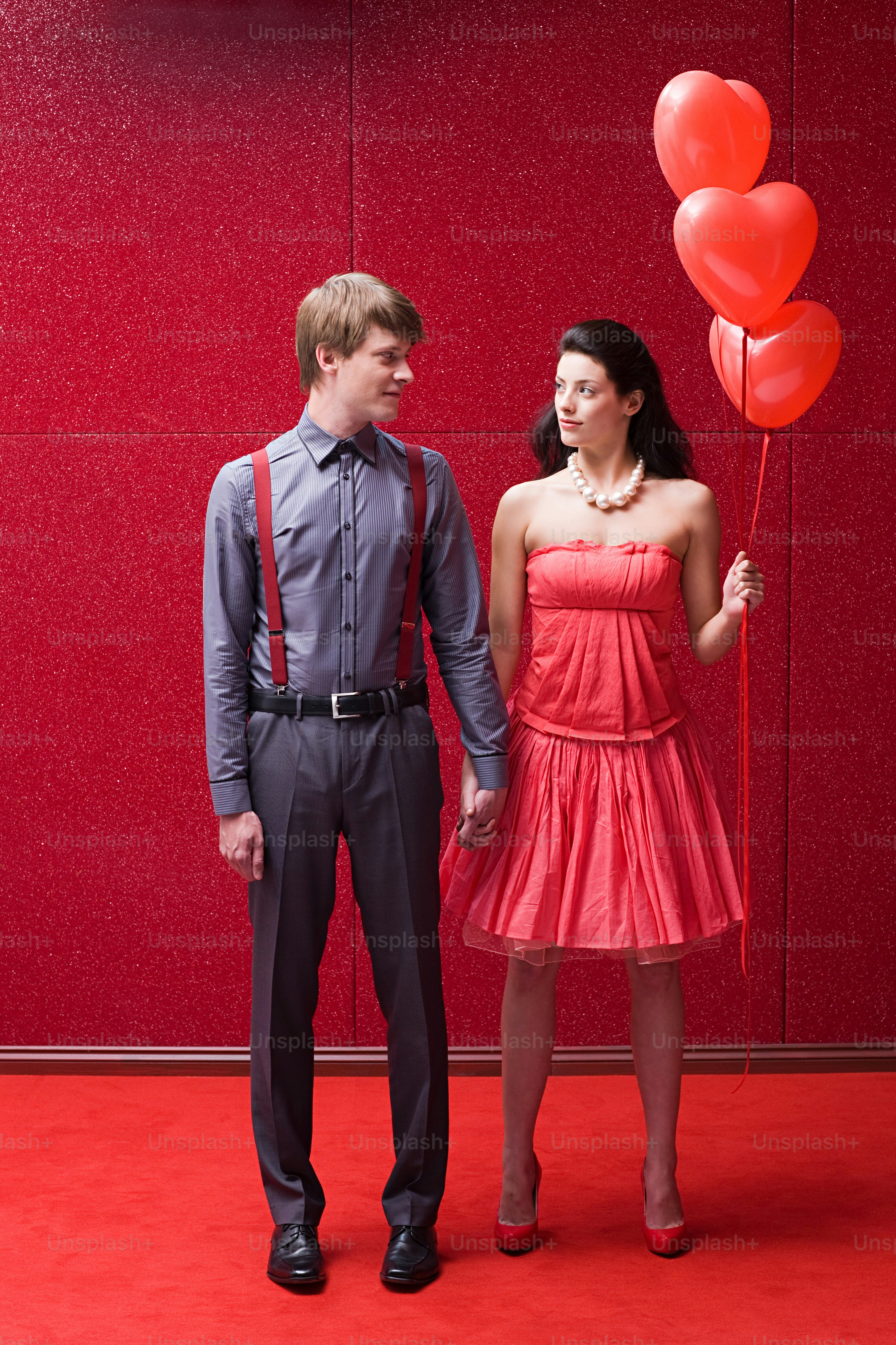 A man and a woman standing next to each other photo – Fashion Image on ...