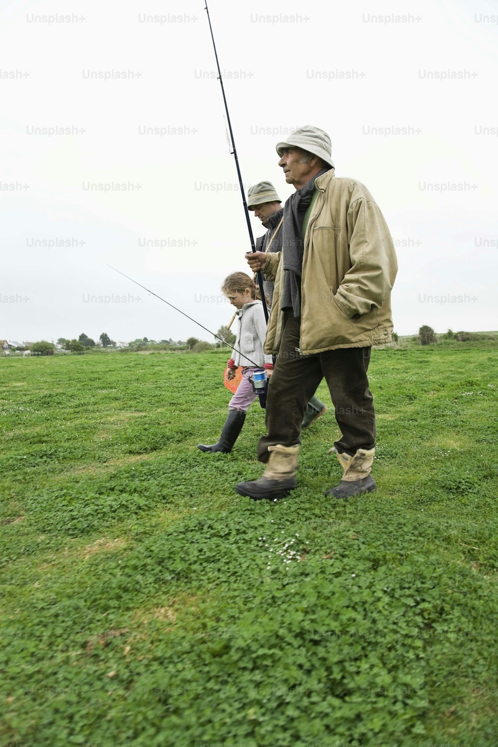 a man and a little girl fishing in a field