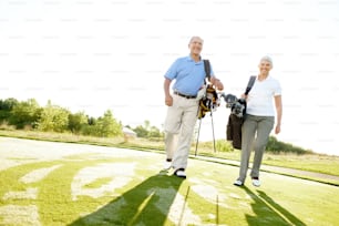 Full length shot of a senior couple walking to their balls along the fairway - Copyspace
