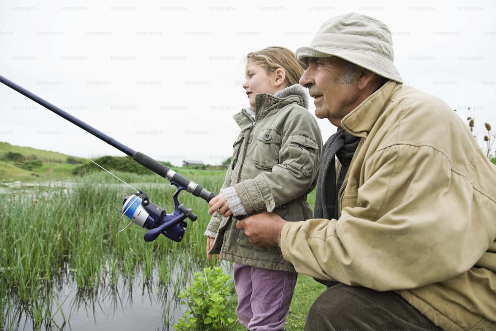 an older man and a young girl fishing