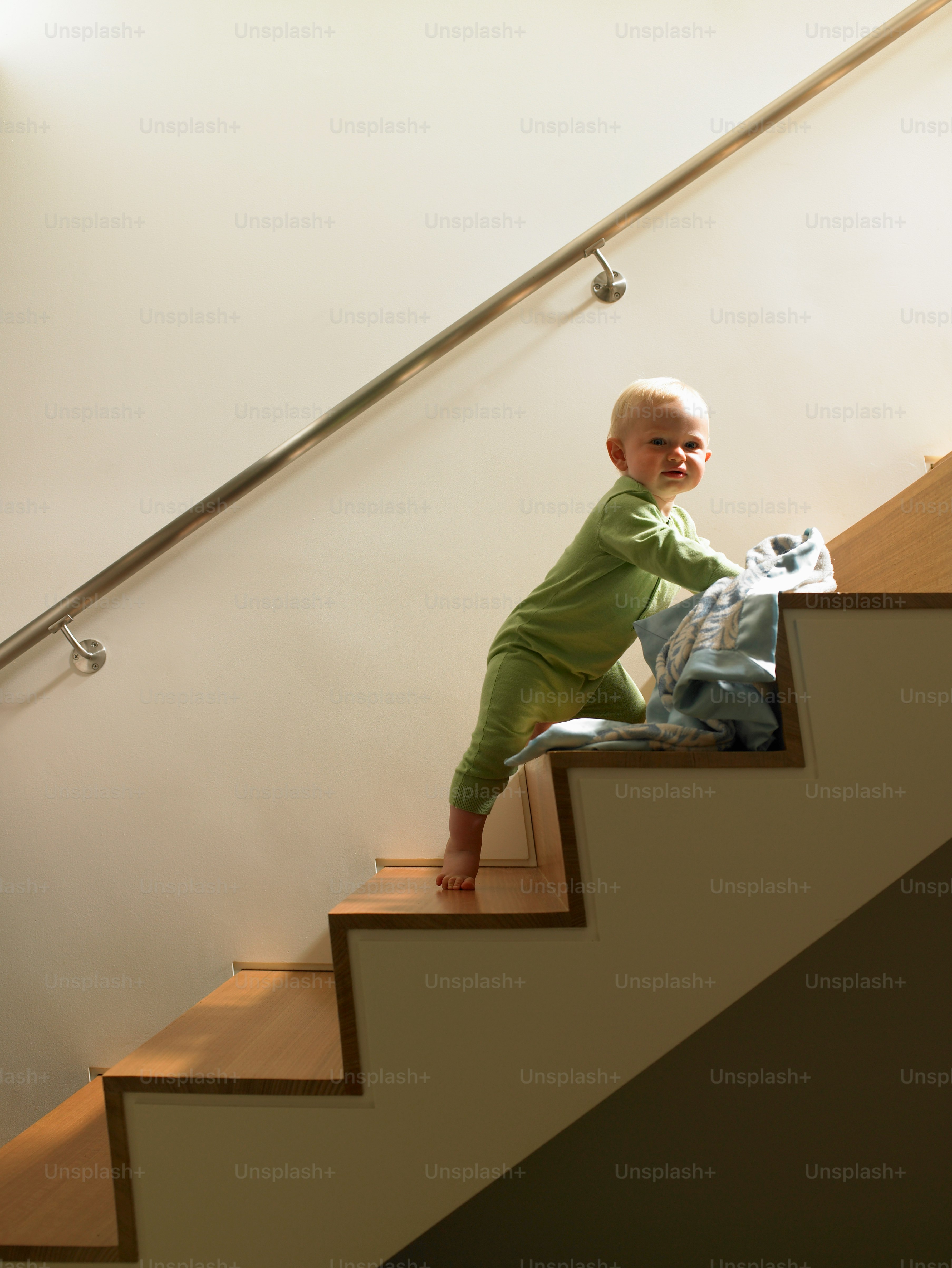 a small child sitting on a stair case