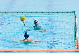 a couple of people playing a game of water polo