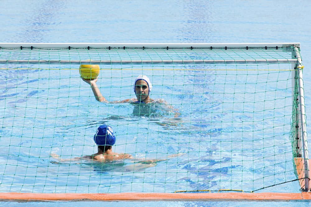 a couple of people playing a game of water polo