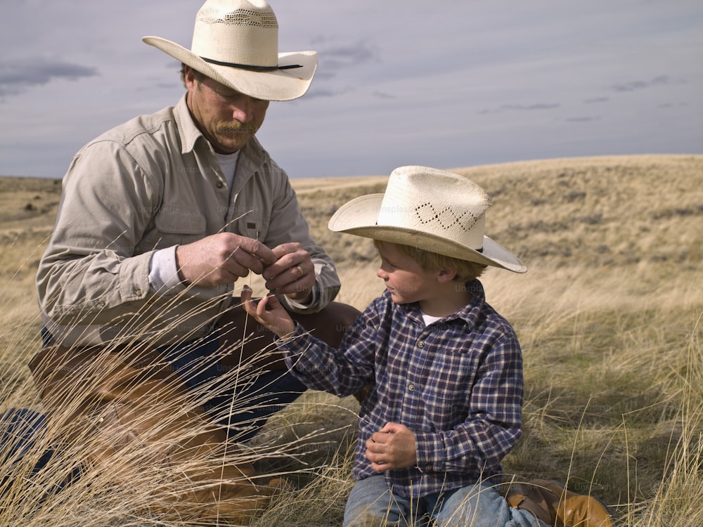 Cowboy and young son studying nature on ranch property in Big Timber, Montana