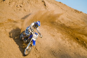 a person riding a dirt bike on a dirt track