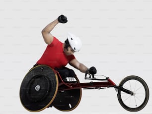 a man in a wheel chair doing a trick