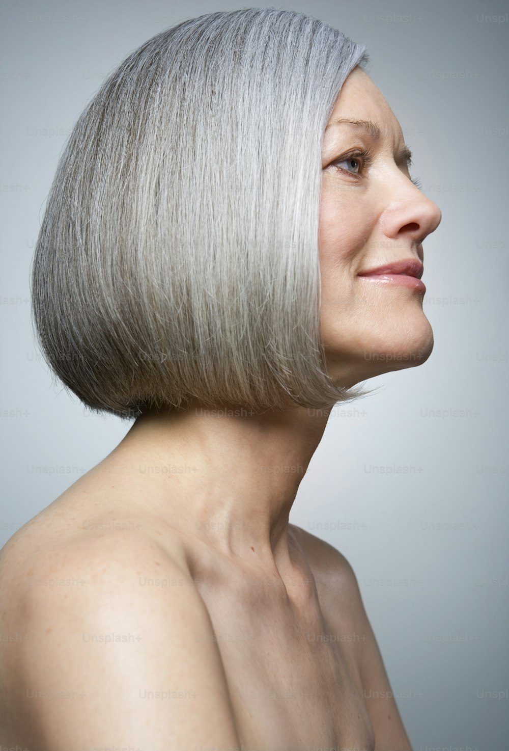 a woman with grey hair and a short bob