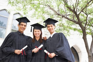 a group of people in graduation gowns posing for a picture