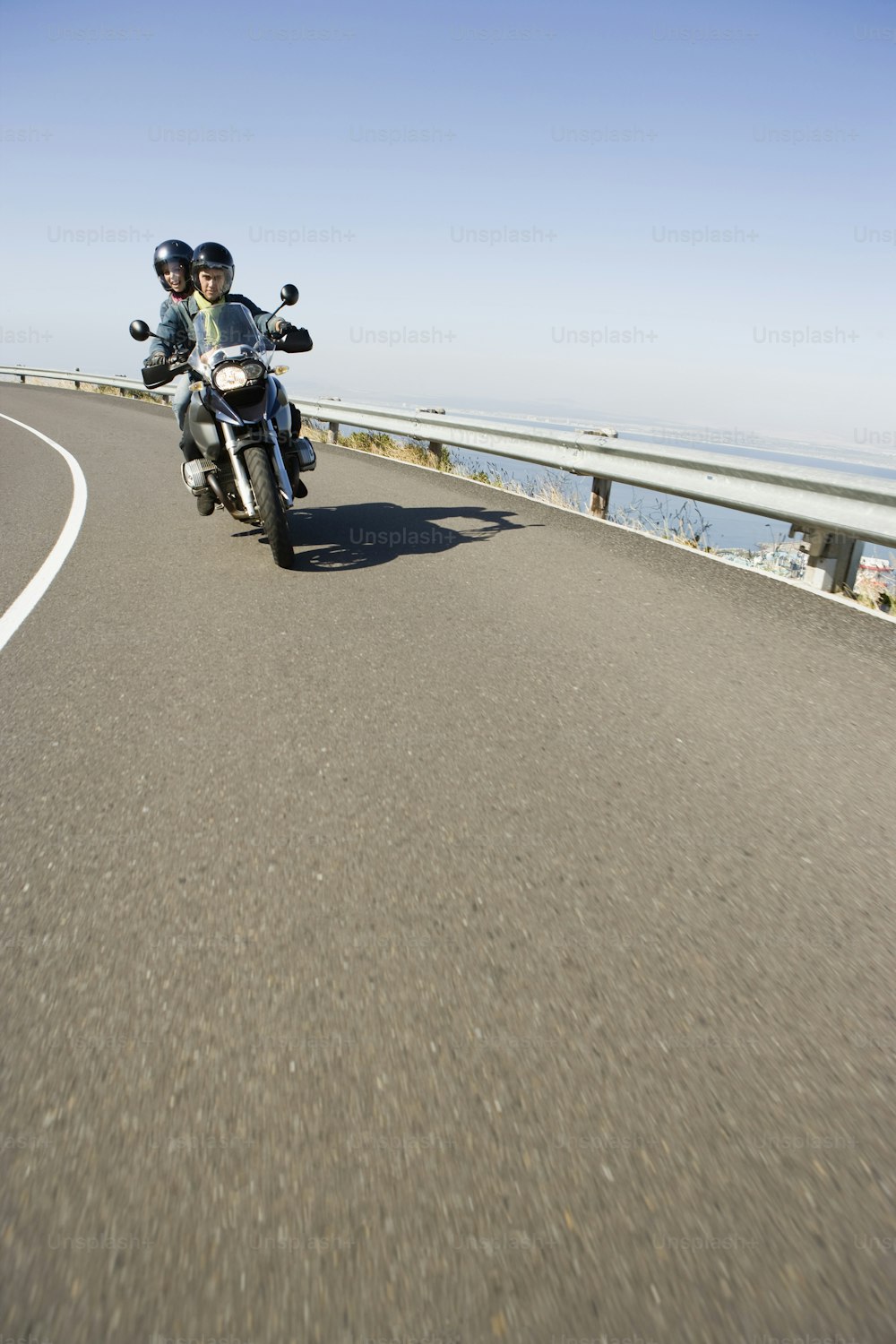 a couple of people riding on the back of a motorcycle