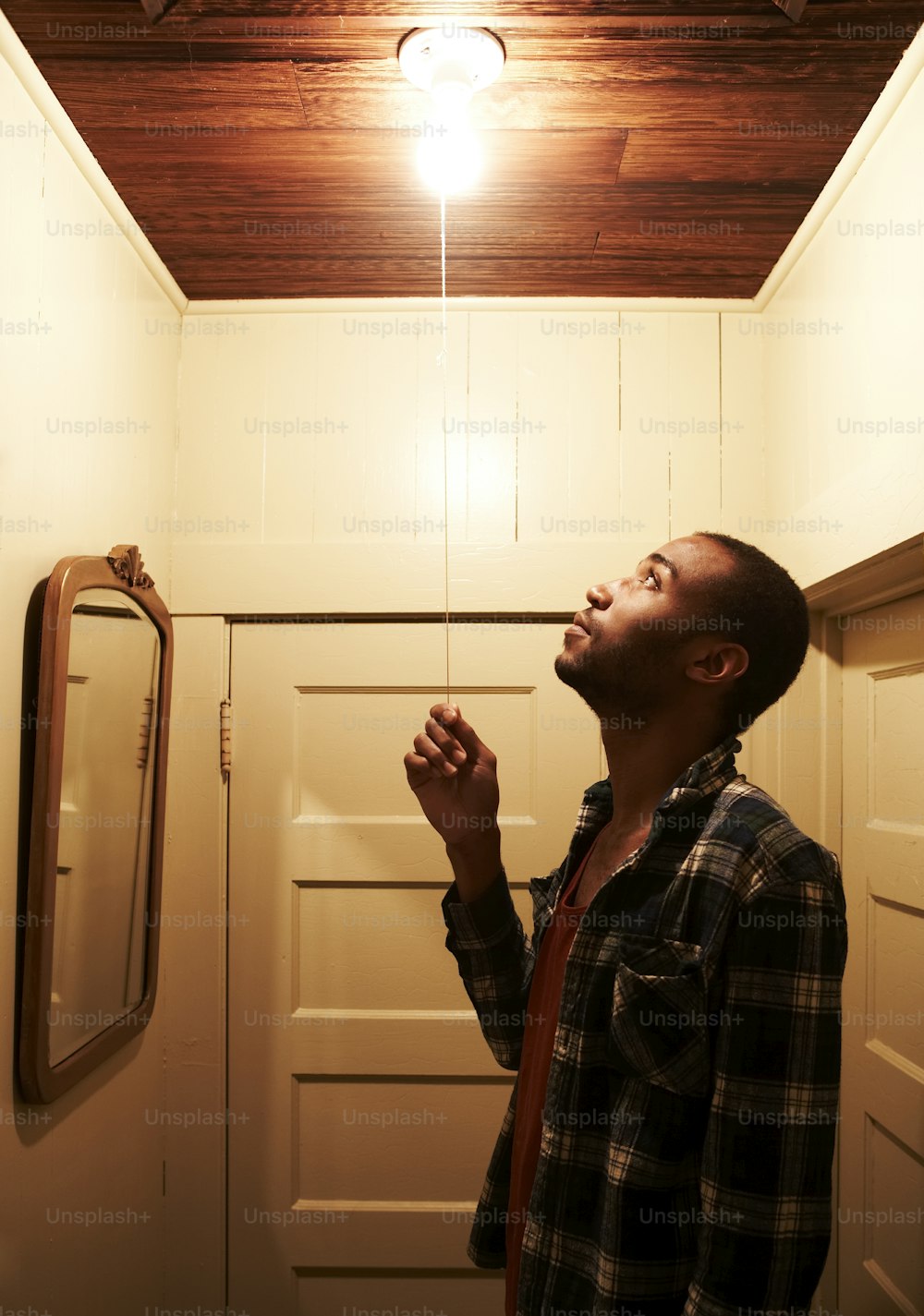 a man standing in front of a mirror in a bathroom