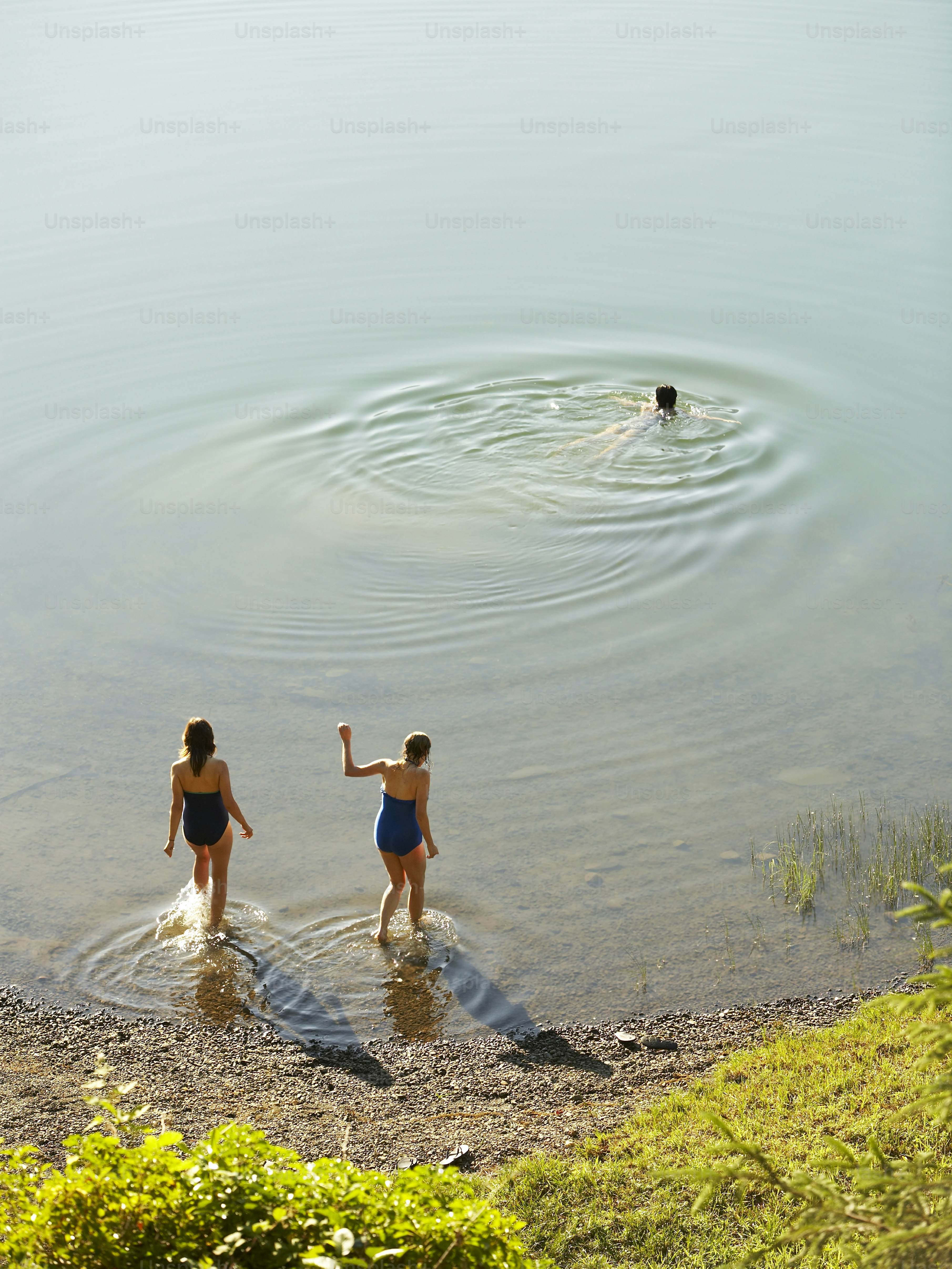 a couple of women standing in a body of water