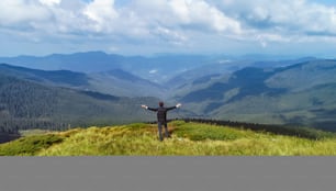 The man standing on the picturesque mountains background