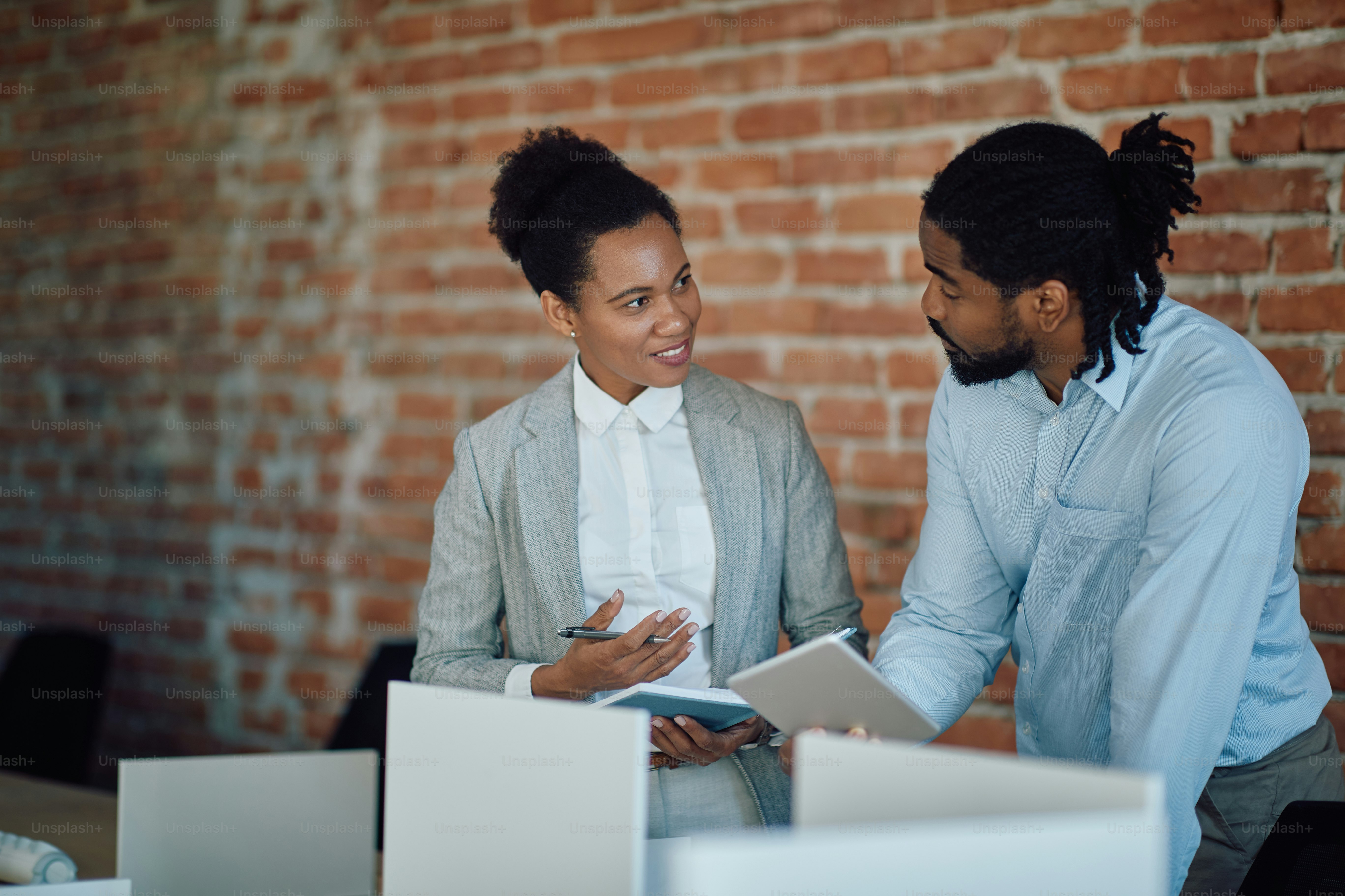 Black entrepreneurs talking to each other while corporate office. Focus is on businesswoman. photo – Communication Image on Unsplash