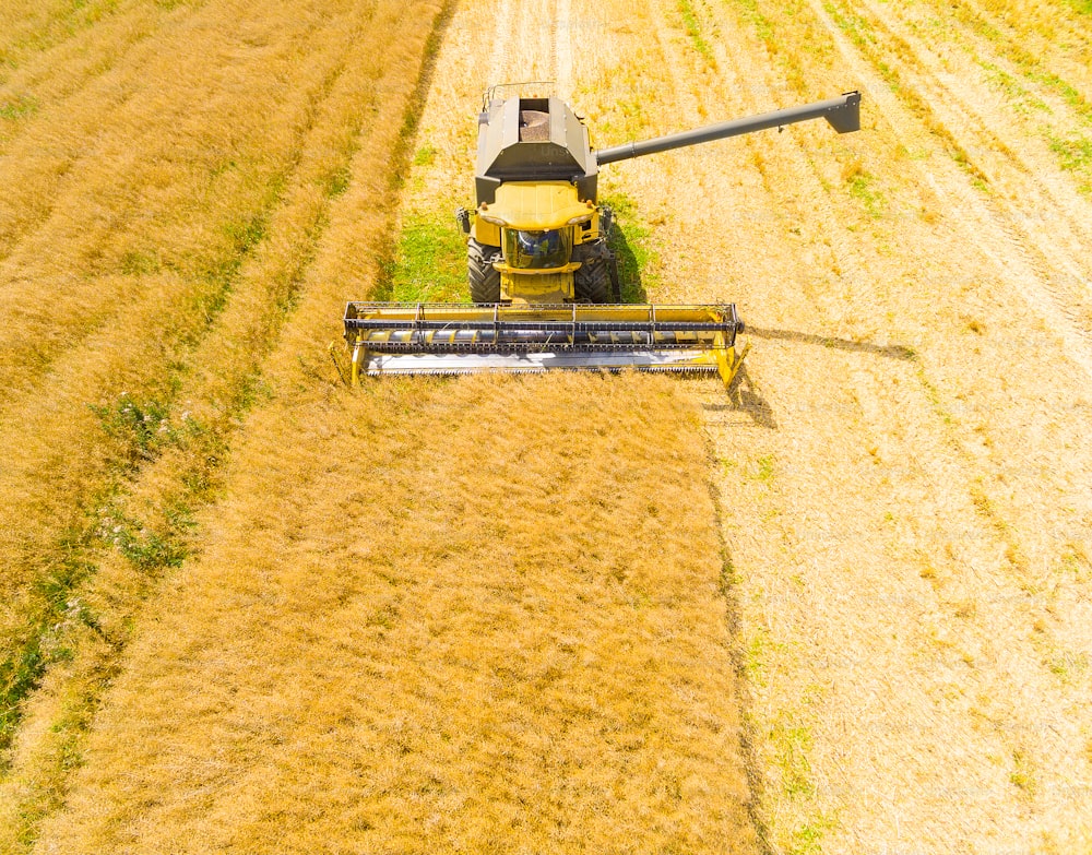 Aerial view of combine harvester. Harvest of wheat field. Industrial footage on agricultural theme. Biofuel production from above. Agriculture and environment in European Union.