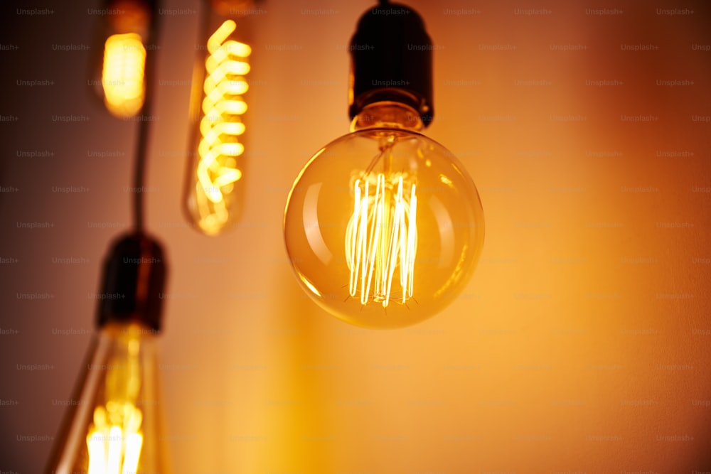 Set of vintage light bulb on orange background, soft focus. Glowing edison bulb