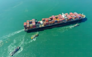 Aerial top view containers ship cargo business commercial trade logistic and transportation of international import export by container freight cargo ship in the open seaport.